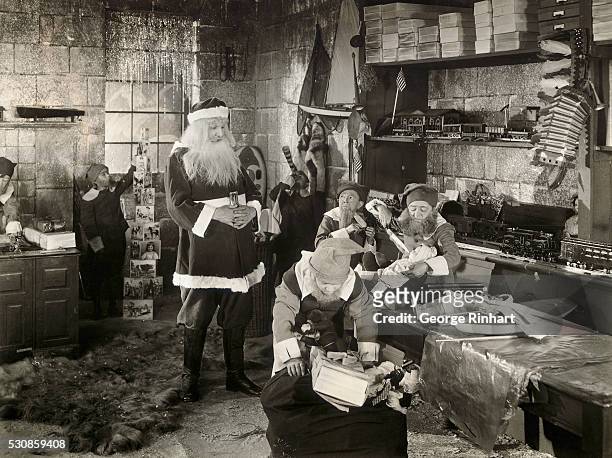 Santa Claus Watching over Elves in Workshop
