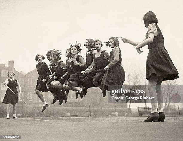 Girls at the Archbishop Tenison school in Lambeth, London jump rope on the playground during recess.