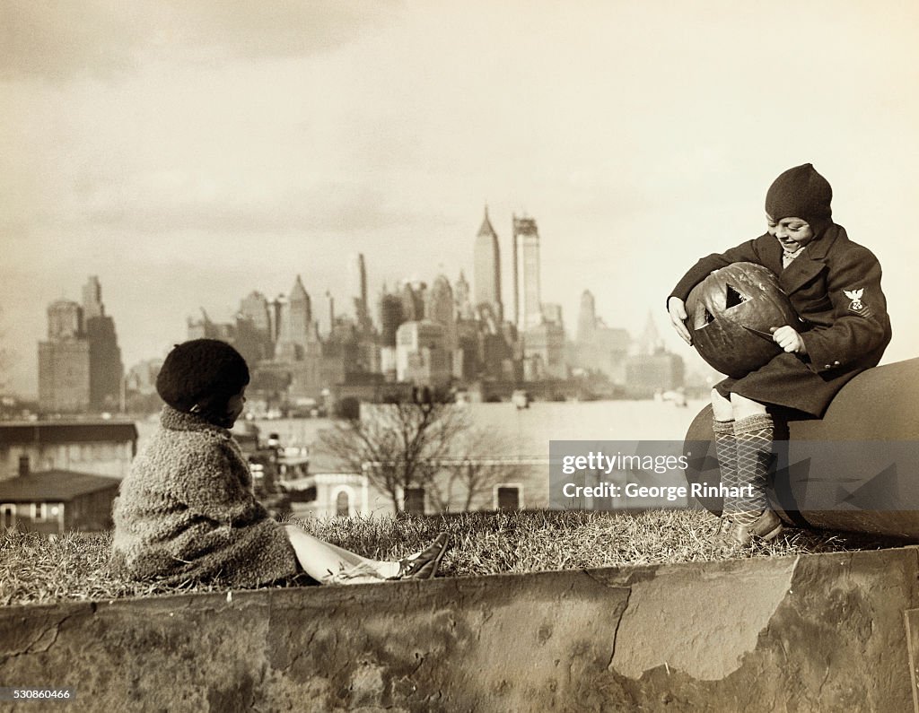 Children Carving Pumpkin with NYC Backdrop