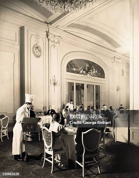 Photo shows a waiter serving food at the French Room of The Cleft in San Francisco, California.