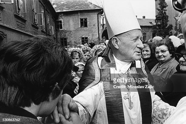 Archbishop Tom??ek greets crowds at the funeral of a bishop.