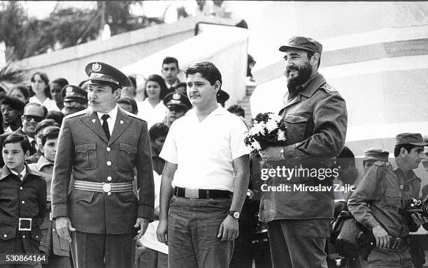 Revolutionary Cuban leader Fidel Castro stands with his brother Raul during a parade marking the anniversary of the revolution.