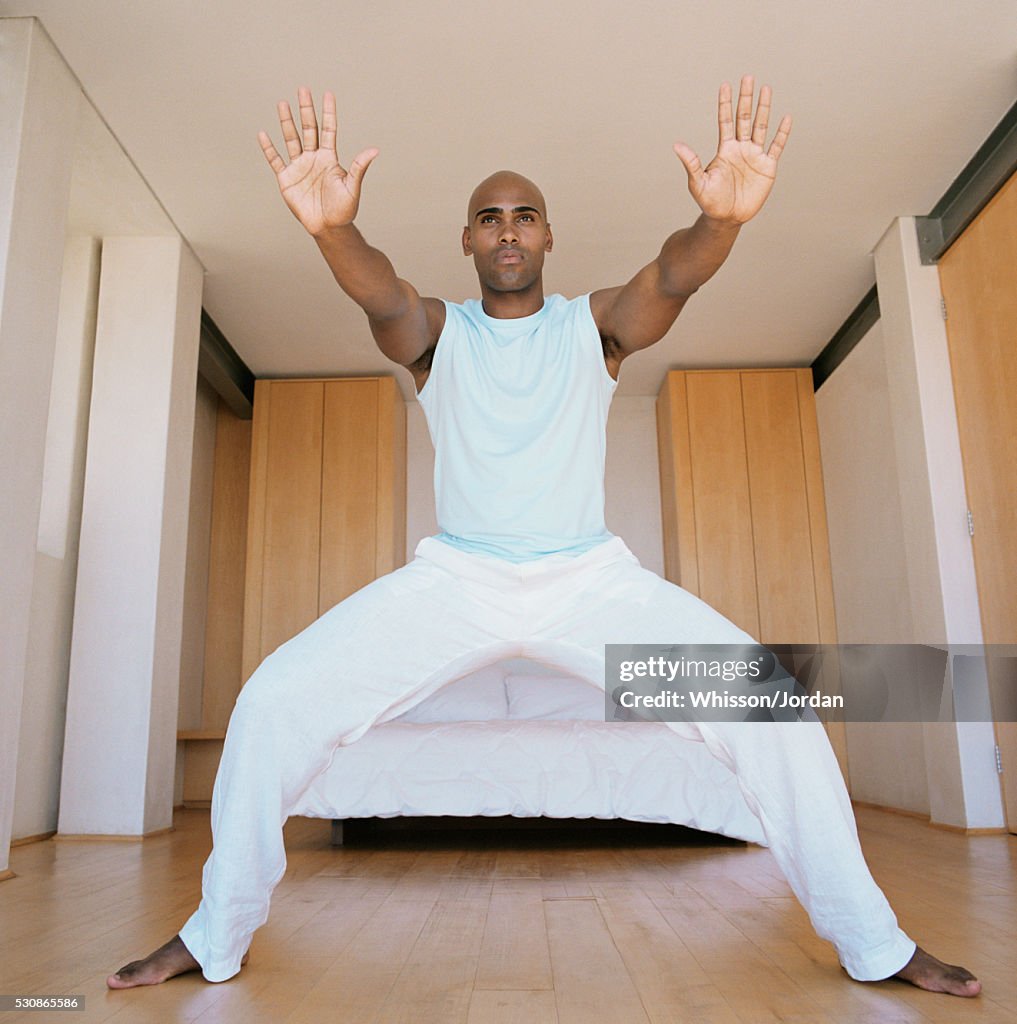 Man doing tai chi in bedroom