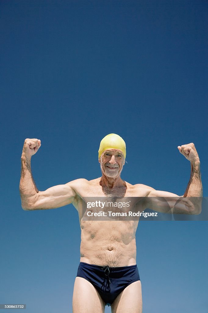 Elderly man flexing arms