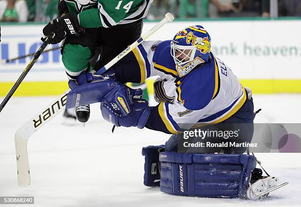 Brian Elliott of the St. Louis Blues makes a save in front of Jamie Benn of the Dallas Stars in the first period in Game Seven of the Western...