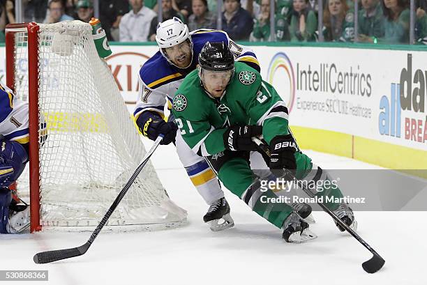 Antoine Roussel of the Dallas Stars skates the puck against Jaden Schwartz of the St. Louis Blues in the first period in Game Seven of the Western...