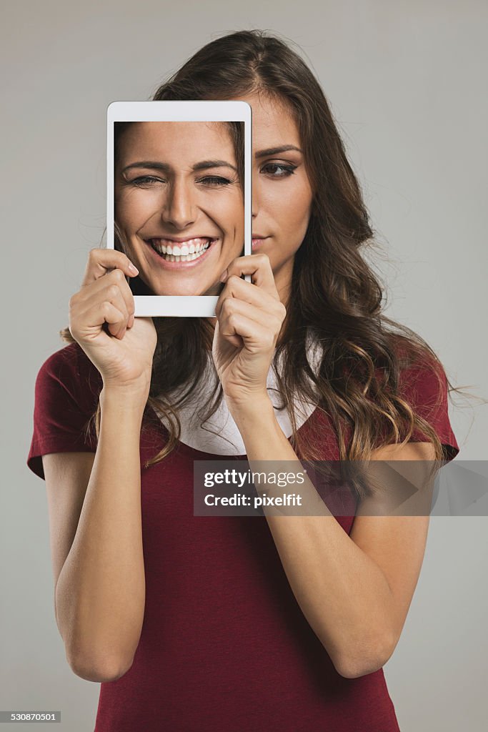 Woman with digital tablet and different faces