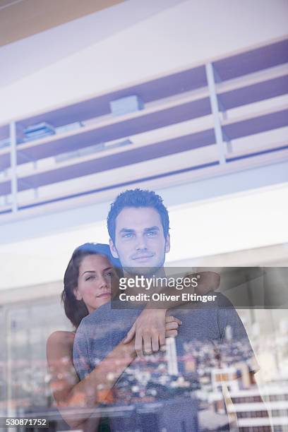 couple looking out window - oliver eltinger stock-fotos und bilder