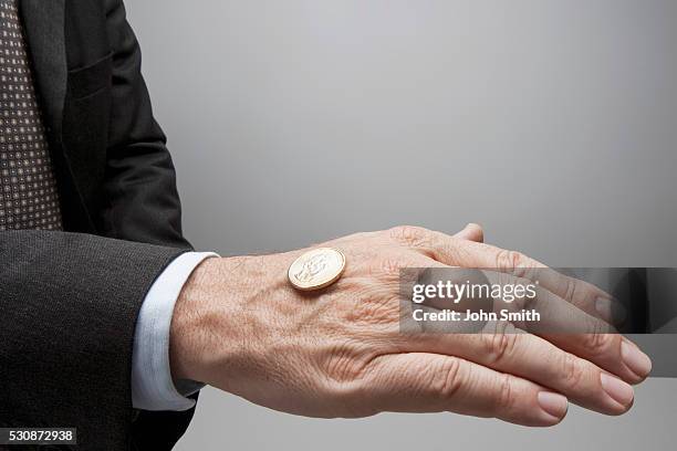 businessman flipping coin - coin toss stockfoto's en -beelden