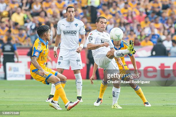 Walter Gargano of Monterrey controls the ball while observed by Javier Aquino of Tigres during the quarter finals first leg match between Tigres UANL...