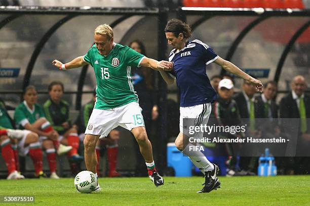 Alexei Smertin of FIFA Legends battles for the ball with Luis Hernandez of MexicanAllstars during an exhibition match between FIFA Legends and...