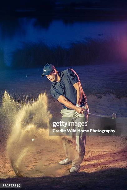 golfer blasting out of sand trap golf - golf bunker stock-fotos und bilder