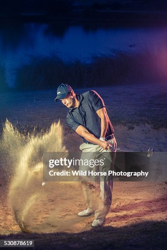 Golfer blasting out of sand trap golf Golfer blasting out of sand trap golf