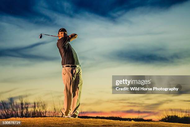 man standing on hill at golf course, swinging - golf swing sunset stock pictures, royalty-free photos & images
