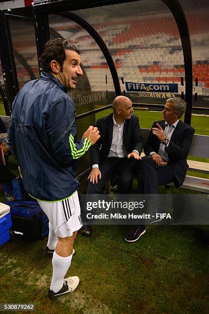 President Gianni Infantino and FIFA Legends coach Jose Mourinho discuss tactics with FIFA Legends player Luis Figo during an exhibition match between...