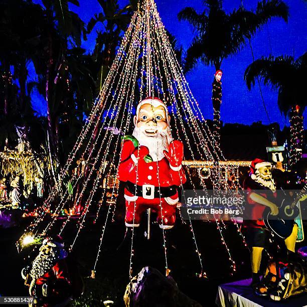 Woodland Hills, Ca - 2 17, 2014. A private home is transformed into a christmas lights display featuring a gargantuan Santa Claus and rocker Santa...