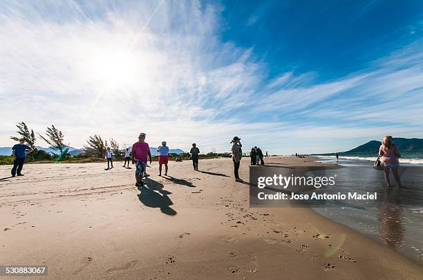 People standing at Praia do Sonho, in the city of Palhoça, next to Florianópolis, Brazil. Taken in August 3rd, 2014.