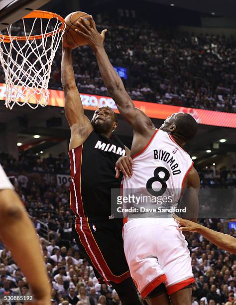 Bismack Biyombo of the Toronto Raptors blocks a shot by Dwyane Wade of the Miami Heat during game 5 of the NBA Eastern Conference Semi Finals at Air...