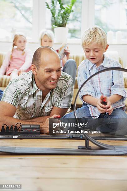 father and son playing with toy cars - car remote toy stock pictures, royalty-free photos & images