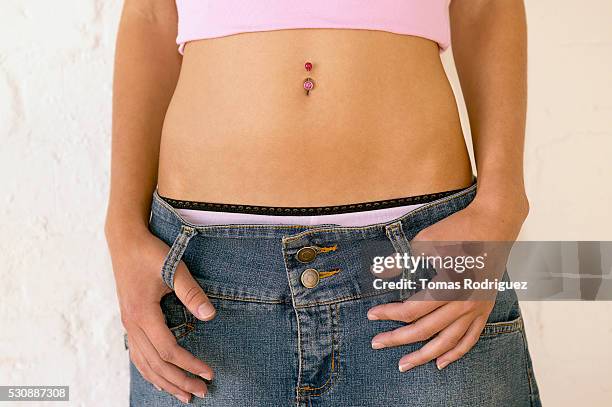 teen girl with navel ring - belly ring foto e immagini stock
