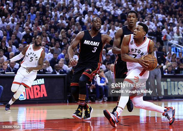Kyle Lowry of the Toronto Raptors drives to the basket as Dwyane Wade and Josh Richardson of the Miami Heat defend in the first half of Game Five of...