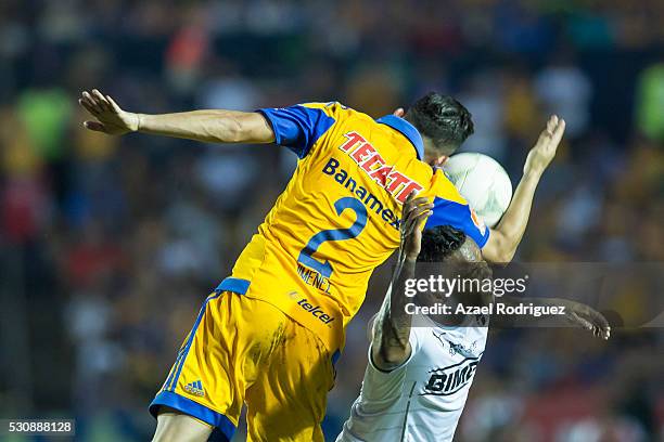 Dorlan Pabon of Monterrey heads the ball with Israel Jimenez of Tigres during the quarter finals first leg match between Tigres UANL and Monterrey as...