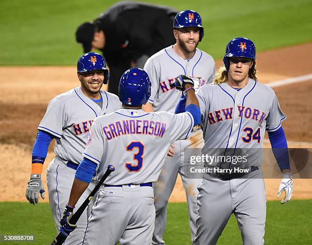 Noah Syndergaard of the New York Mets celebrates his three run homerun and second homerun of the game with Eric Campbell, Rene Rivera and Curtis...