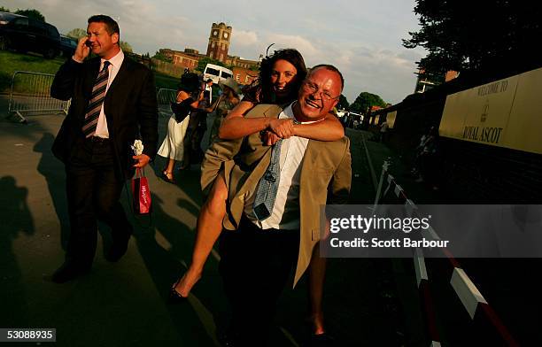 Man gives a lady race goer a piggy back ride home after attending the third day, Ladies Day of Royal Ascot 2005 at York Racecourse on June 16, 2005...