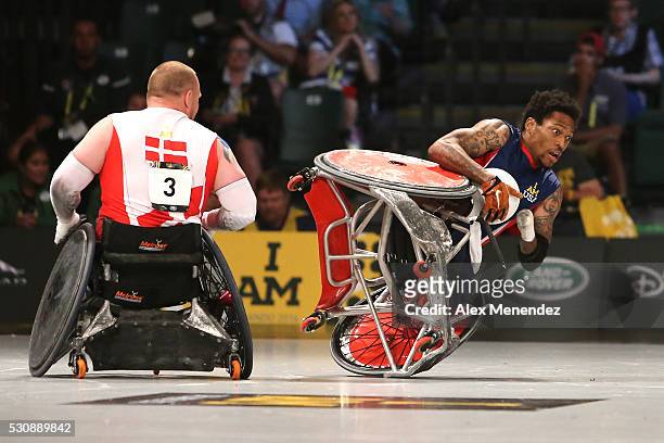Anthony McDaniel falls over after being hit by Mark Peters of Denmark during the Invictus Games Orlando 2016 Wheelchair Rugby Finals at the ESPN Wide...