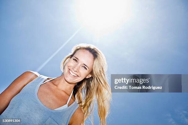 young woman smiling - tank top stock pictures, royalty-free photos & images