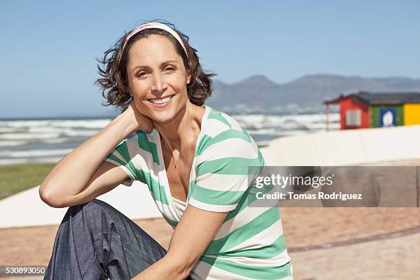 woman sitting on a beach - 40 49 år bildbanksfoton och bilder