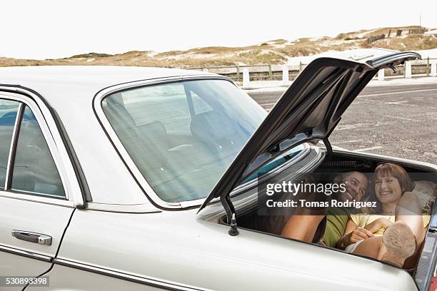 couple together in trunk - flirting funny stock pictures, royalty-free photos & images