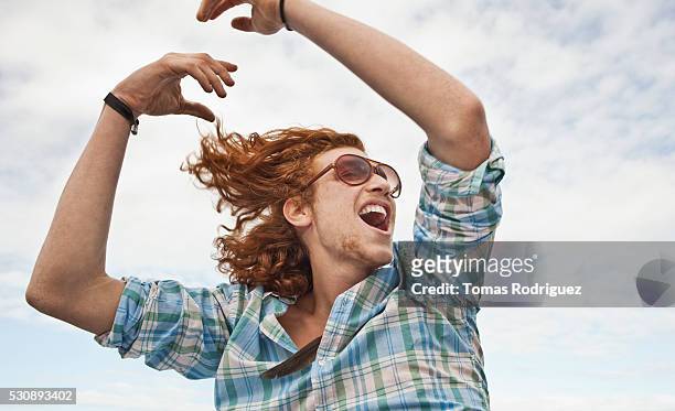 young man outdoors - joy stock-fotos und bilder