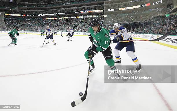 Jamie Benn of the Dallas Stars skates the puck against Paul Stastny of the St. Louis Blues in the third period in Game Seven of the Western...