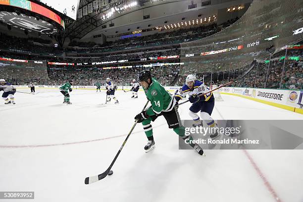 Jamie Benn of the Dallas Stars skates the puck against Paul Stastny of the St. Louis Blues in the third period in Game Seven of the Western...