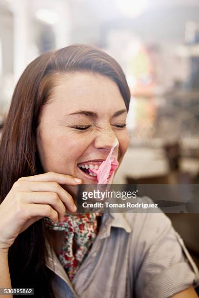 woman blowing gum bubble - bubble gum stock pictures, royalty-free photos & images