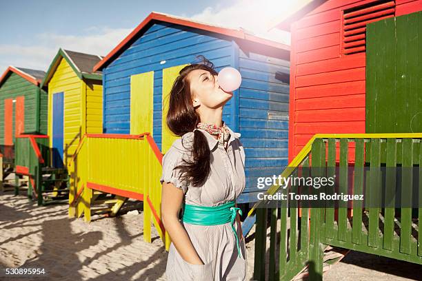 woman blowing bubble gum outdoors - bubble gum stock pictures, royalty-free photos & images