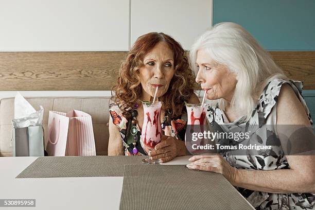 friends sipping on ice cream sundaes - ice cream sundae stockfoto's en -beelden