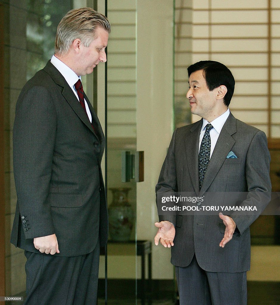 Belgian Crown Prince Philippe (L) chats