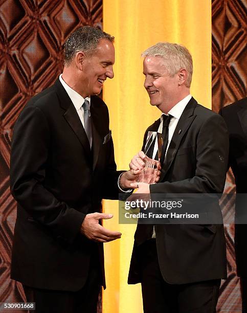 President & CEO Mike O'Neill and composer Blake Neely pose with the BMI Film and Television Awards for 'Supergirl' onstage during the 2016 BMI...