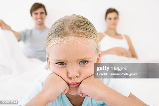 girl pouting, parents in background - double facepalm stock pictures, royalty-free photos & images