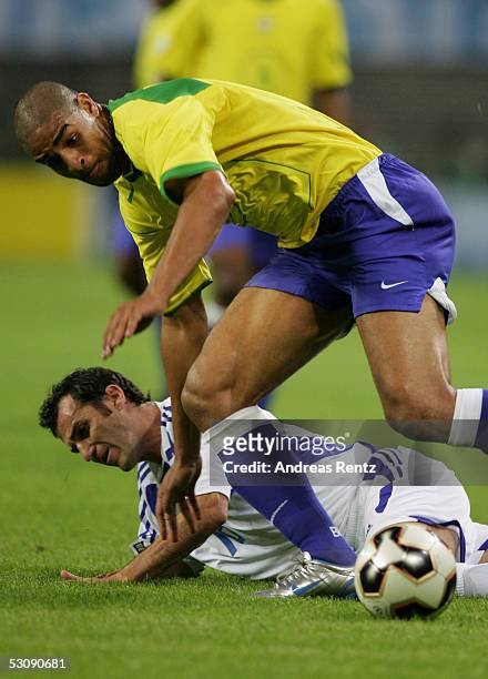 Adriano of Brazil challenges with Ioannis Goumas of Greece during the FIFA Confederations Cup 2005 match between Brazil and Greece on June 16, 2005...