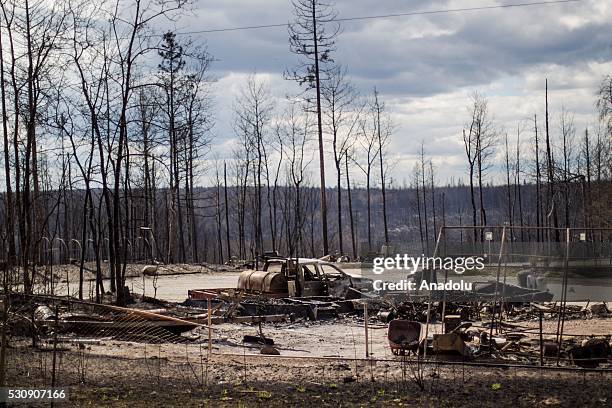 Burned cars and rubble are seen during a wildfire that erupted outside Fort McMurray, Alberta, Canada on May 11, 2016. Wildfire erupted on 3 May...