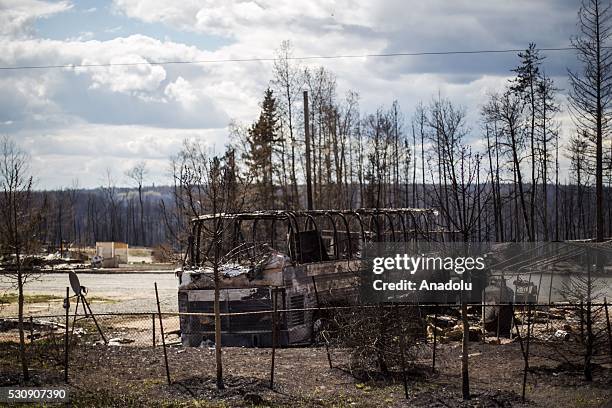 Burned cars and rubble are seen during a wildfire that erupted outside Fort McMurray, Alberta, Canada on May 11, 2016. Wildfire erupted on 3 May...