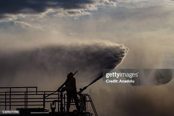 Fire support crew extinguish a wildfire that erupted outside Fort McMurray, Alberta, Canada on May 11, 2016. Wildfire erupted on 3 May consuming 200...