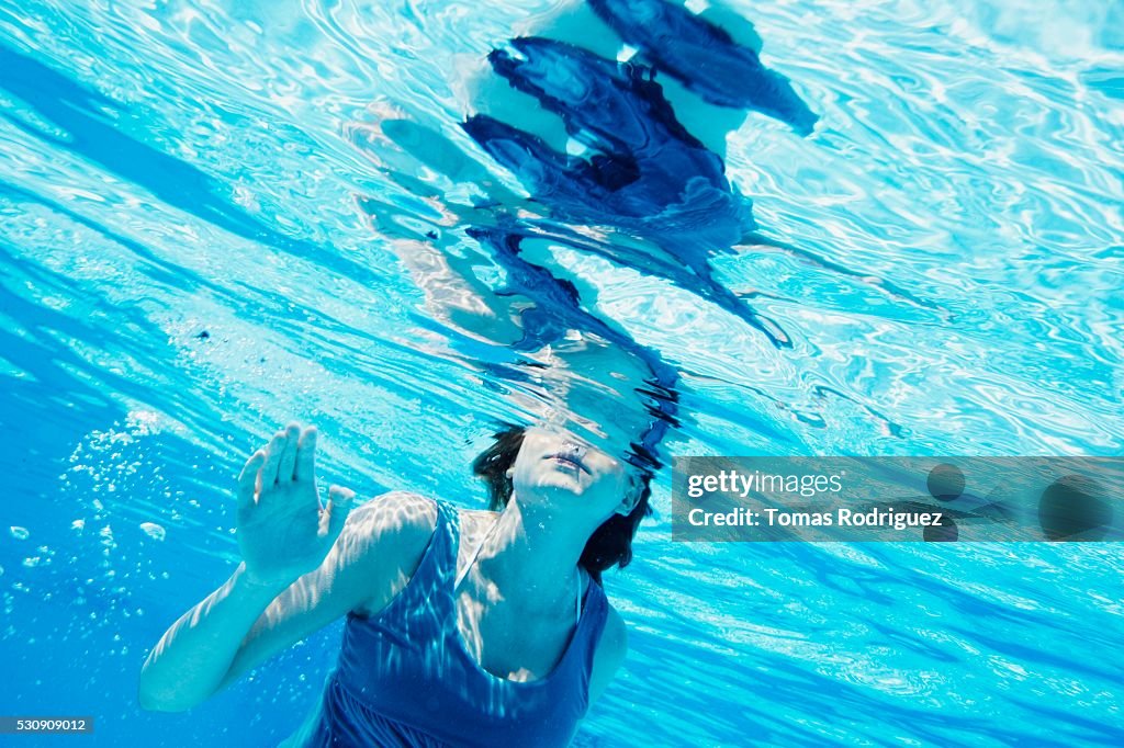 Woman Floating In Pool Woman Floating In Swimming Pool High-Res Stock Photo - Getty Images
