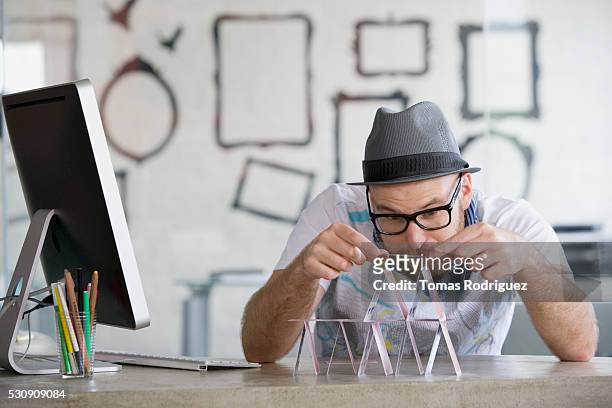man building a house of cards - bored at work stock pictures, royalty-free photos & images