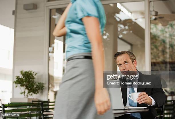 businessman looking at passing woman - sexual harassment stock pictures, royalty-free photos & images