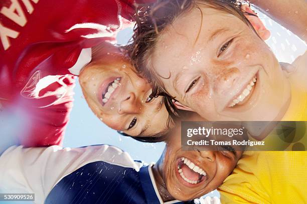 laughing soccer players - menschengruppe begeisterung stock-fotos und bilder