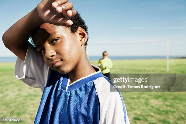 tired soccer player - boys soccer stock pictures, royalty-free photos & images